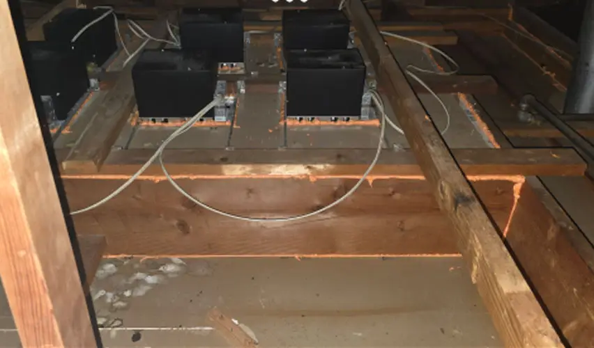 Exposed Attic with Wooden Beams and Electrical Components for Insulation Installation